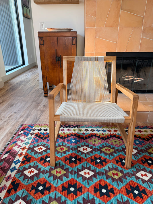 Handwoven Turkish kilim rug Sedona in size 10x8 made from natural wool with a wooden chair and a fireplace