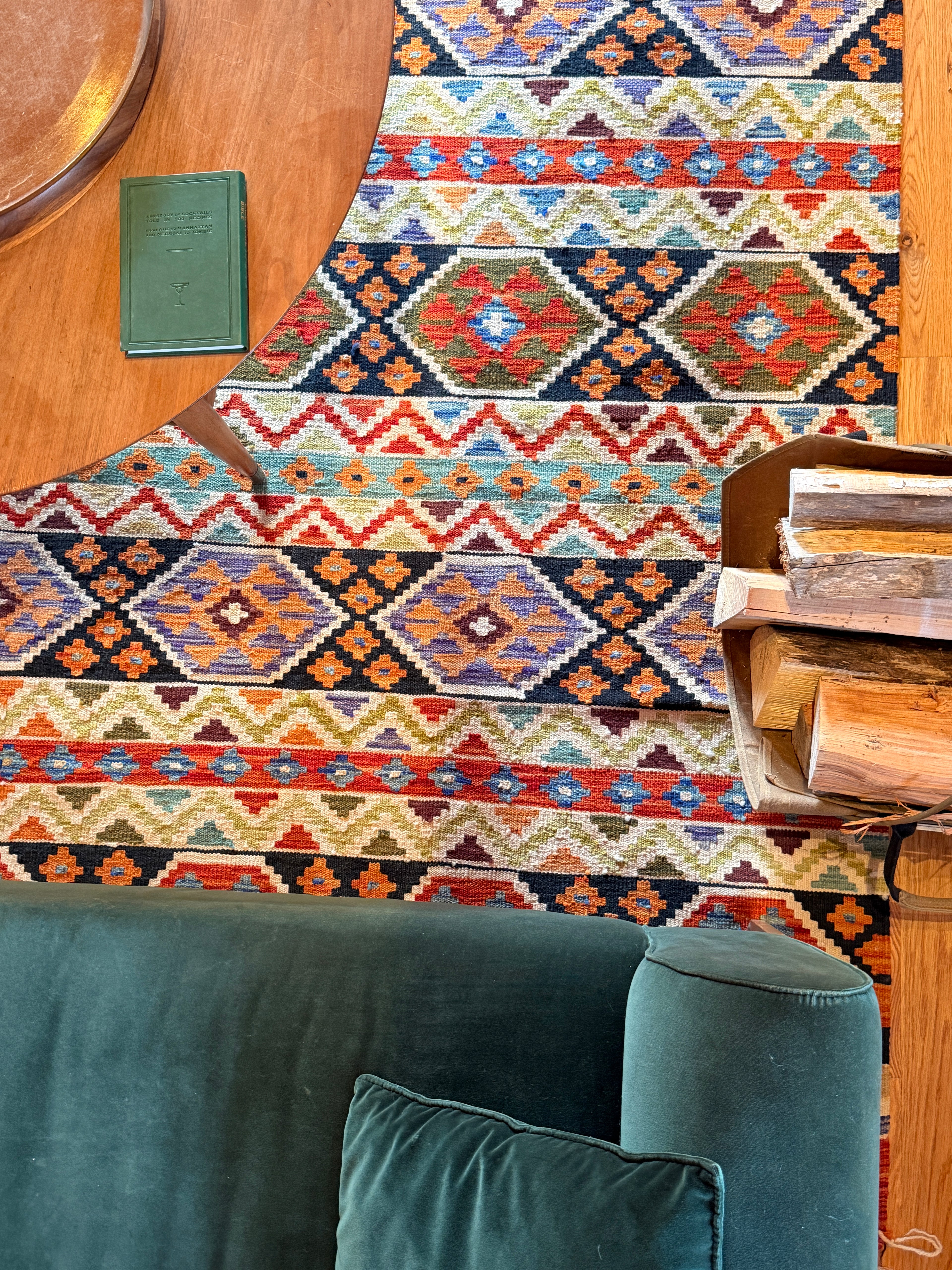 Loomvana turkish kilim rug Savannah handwoven wool detail with a green couch and wooden table.